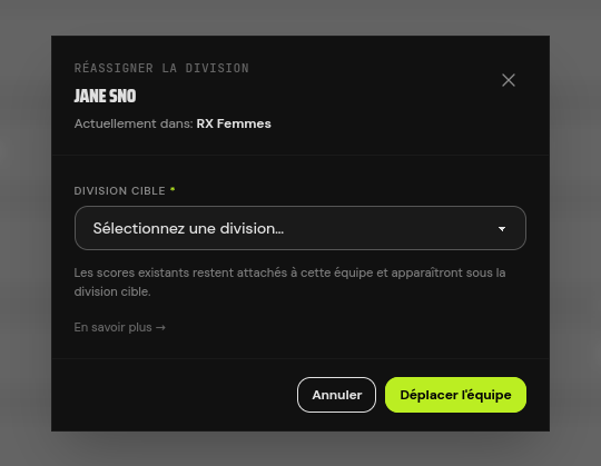 La fenêtre de réassignation affiche la division actuelle de l'équipe, un menu déroulant pour choisir la cible, la note rassurante sur les scores existants, et les boutons Annuler / Déplacer l'équipe.